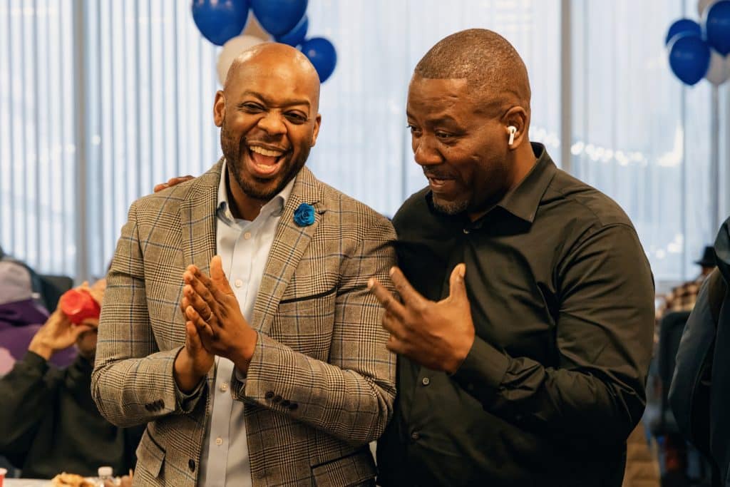 Two men laughing and fellowshipping at a GMen event