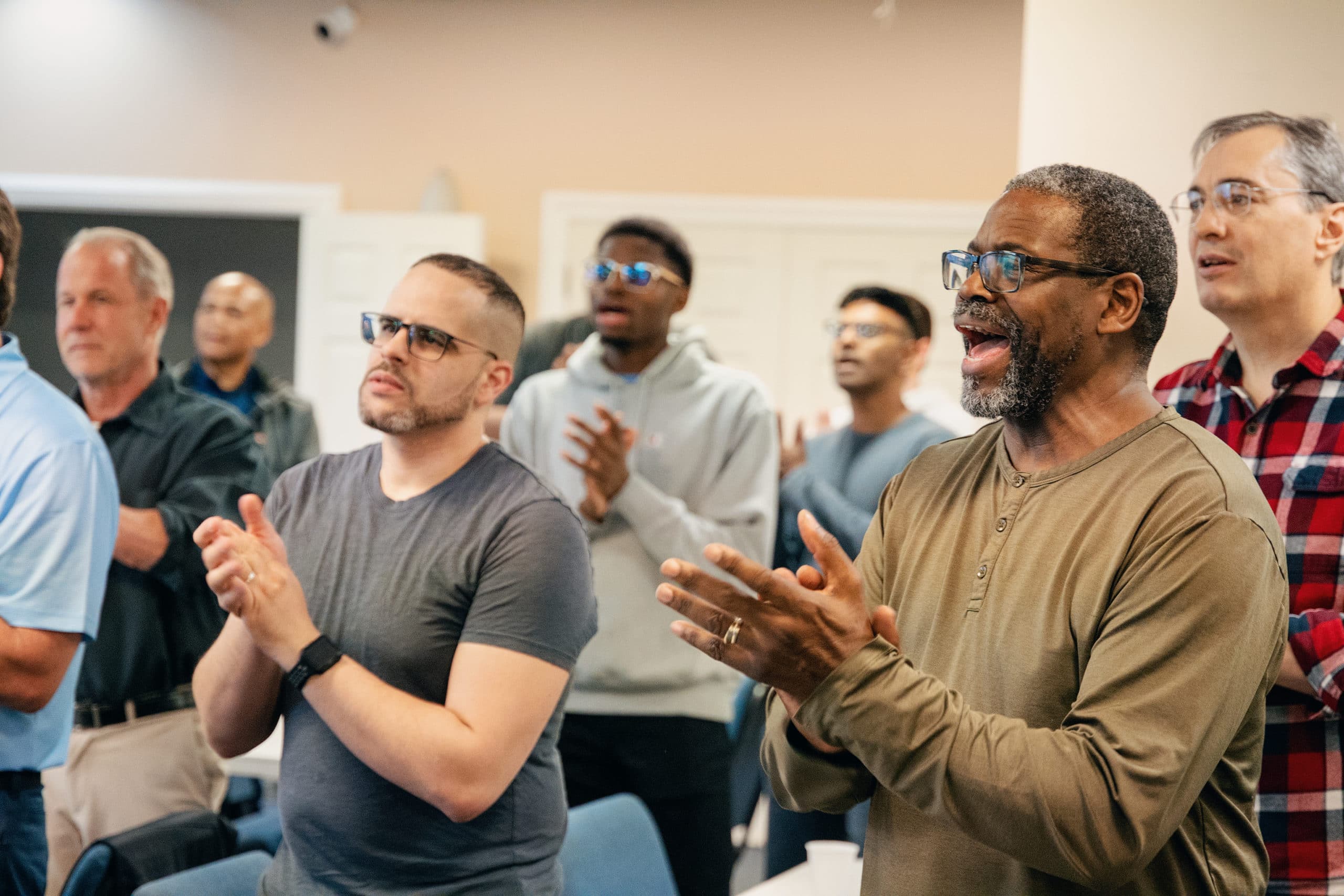 Men worshipping at a GMen event