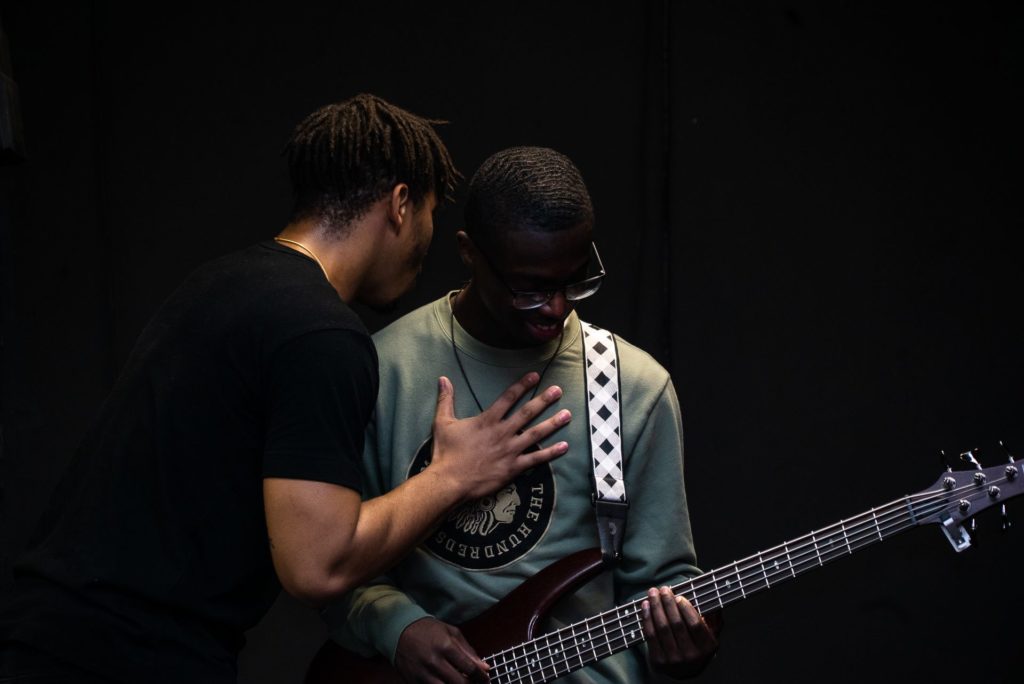 Pastor Joe Mott prays for a young musician