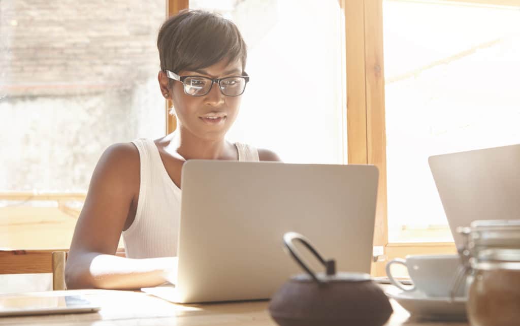 Young female watching or working on laptop