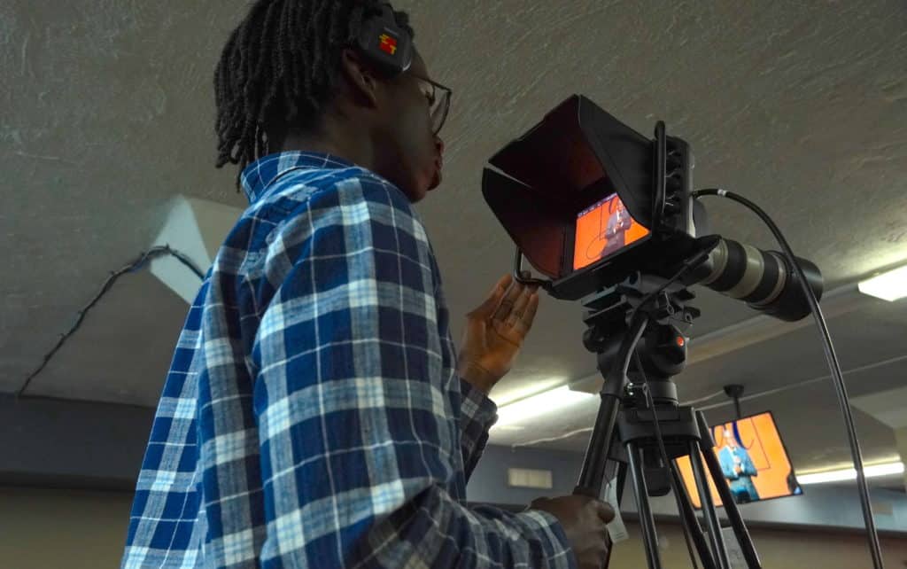 Young volunteer operating a video camera at Generations Church