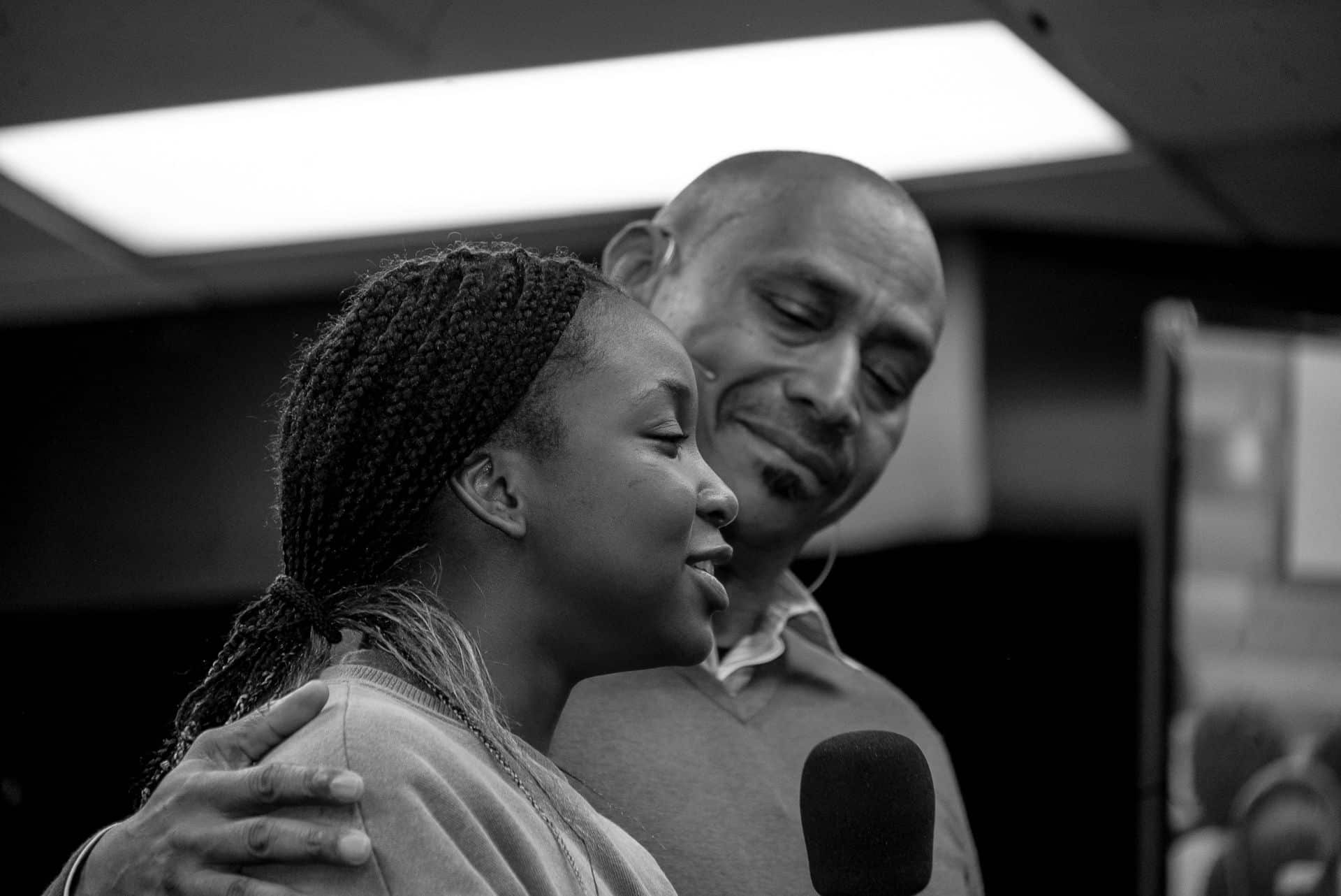 Bishop Mott encouragingly holding the shoulder of a young church member