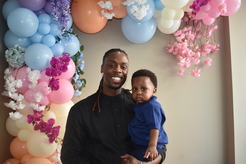 A young father and his baby during Father's Day at Generations Church